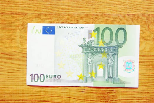 banknotes of euro isolated on a wood background