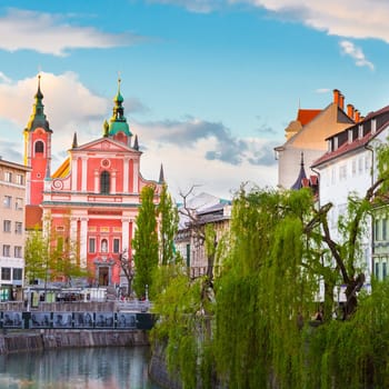 Romantic medieval Ljubljana's city center, capital of Slovenia, Europe. Banks of river Ljubljanica where many bars and restaurants take place. Franciscan Church in background