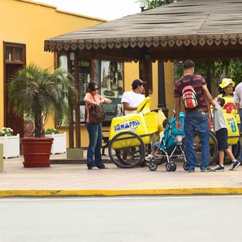 LIMA,PERU - APRIL 19,2012: Unidentified mobile ice cream vendor selling ice cream to unidentified people on Pedro de Osma Avenue in the district of Barranco on April 19,2012 in Lima,Peru.