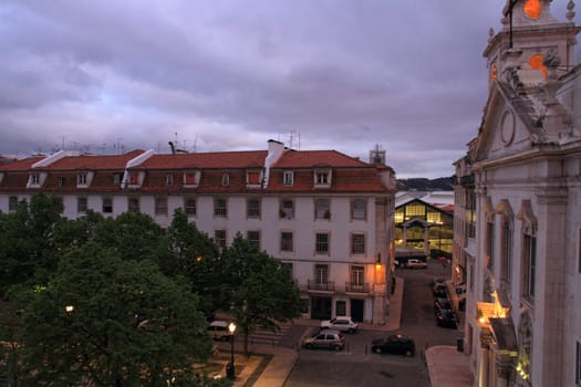The Church Paroquial de Sao Paulo in the Cais Sodre area of Lisbon along with the trees and homes in the plaza in front. In the background is seen the back entrance to the Mercado Ribeira (Ribeira Market).