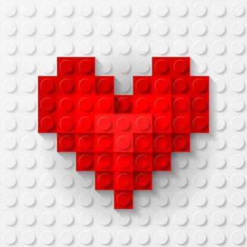 Plastic red heart on white background made of construction kit