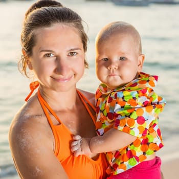 Baby and mother on the tropical beach