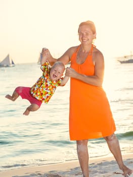 Baby and mother on the tropical beach