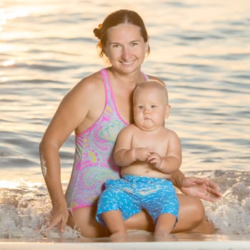 Baby and mother on the tropical beach