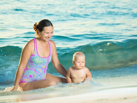 Baby and mother on the tropical beach