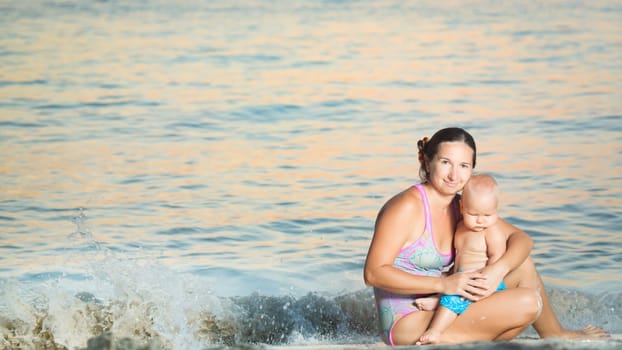 Baby and mother on the tropical beach
