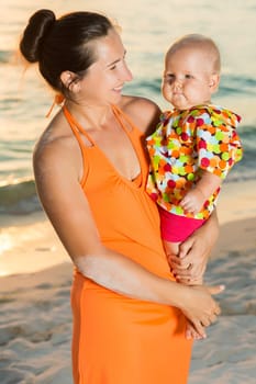 Baby and mother on the tropical beach
