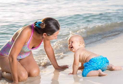 Baby and mother on the tropical beach