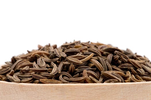 Pile of cumin seeds isolated on white background
