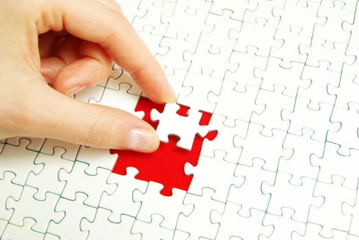 hands holding a puzzle piece . business concepts