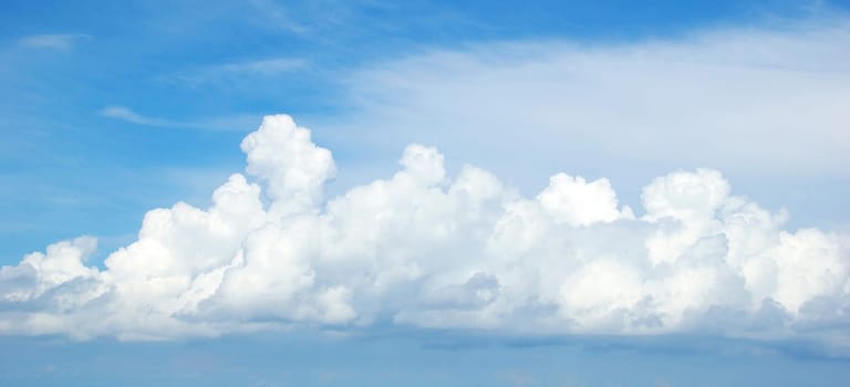 Blue sky background with tiny clouds