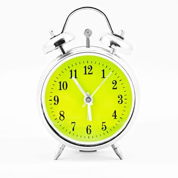 Alarm clock on white background. Showing time five minutes before six