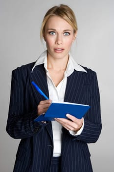 Shocked business woman writing check