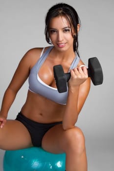 Happy young fitness woman exercising