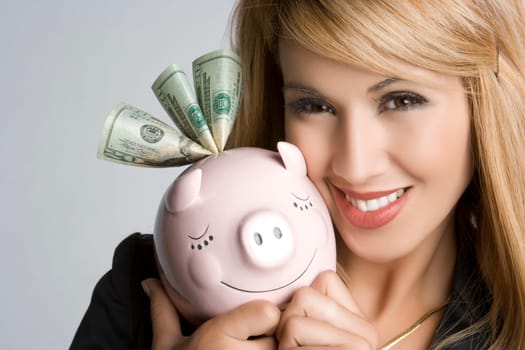 Smilng woman holding piggy bank