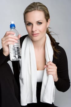 Beautiful fitness woman drinking water