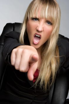 Angry blond business woman pointing yelling