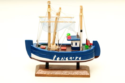 Beautiful miniature ship. Wooden sailship figurine. Antique model sailing boat isolated on white