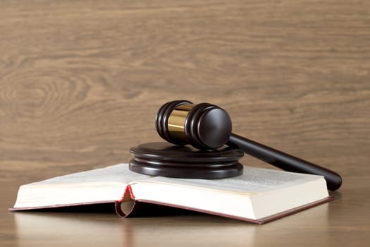 wooden gavel and books on wooden table
