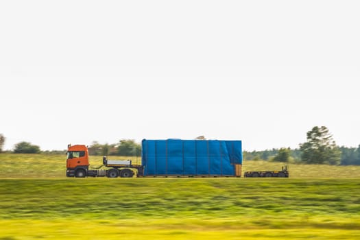 Truck delivery oversized cargo on the country road