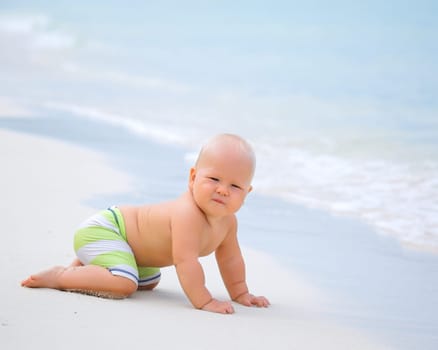 Cute baby on the tropical beach