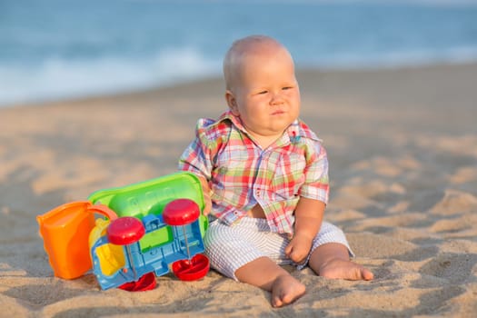 Cute baby is playing toy car