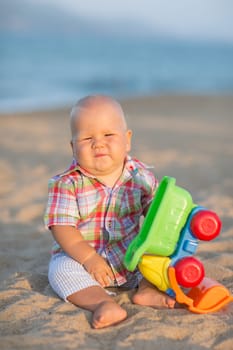 Cute baby is playing toy car