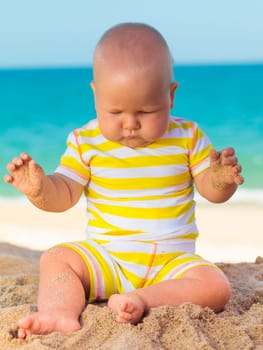 Cute baby on the tropical beach