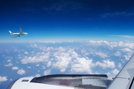 Plane,flying above the clouds in bright weather