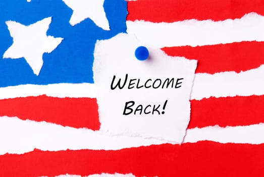 Welcome Back Note on an American Flag Background