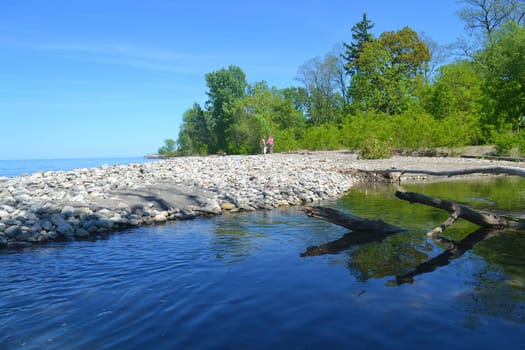 Lakeshore on the lake Ontario on a beautiful sunny spring day with blue sky..