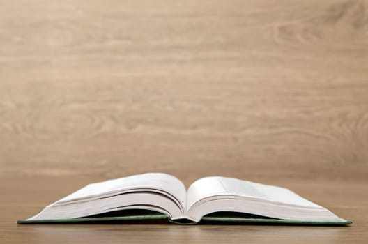 Open book on wood background