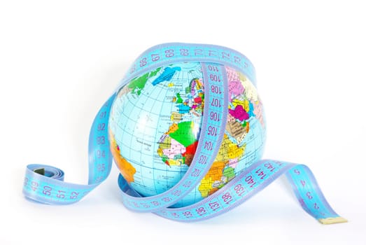 Measuring tape stretched across globe on white