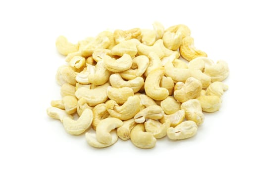 Pile of roasted cashew nuts in isolated white background