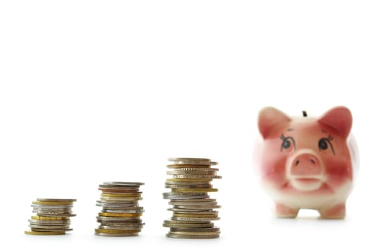 Pink piggy bank  isolated on white background with coins