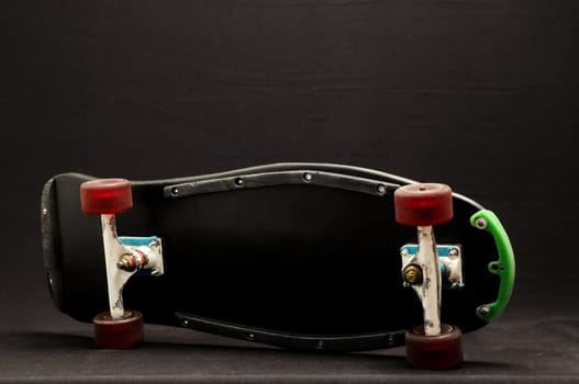 Vintage Style Black Skateboard on a black Background
