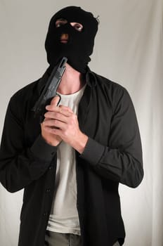 Black Dressed Young Man Holding a Pistol Gun