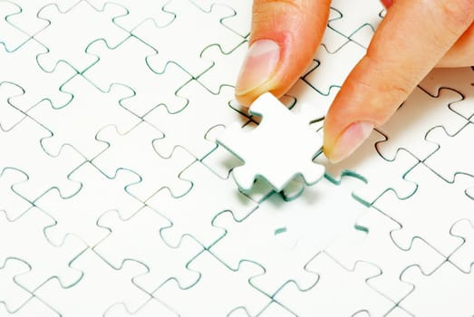 hands holding a puzzle piece . business concepts