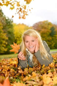 young woman with autumn leaf