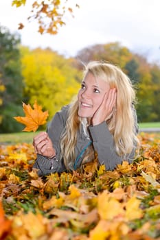 young woman with autumn leaf