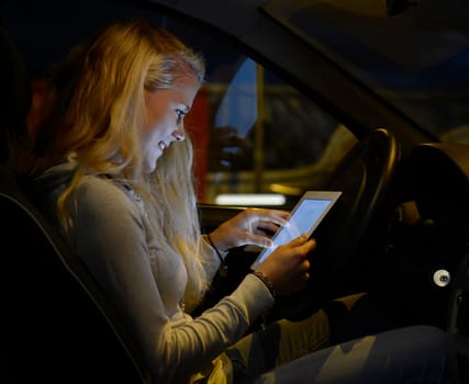 Woman with tablet computer in car
