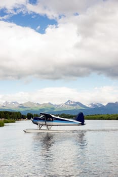 A bush plane performs take off/landing in Alaska with Chugach Mountains in the Background