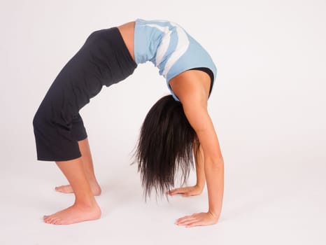 Young adult female prepares to turn herself back over after performing some stretches