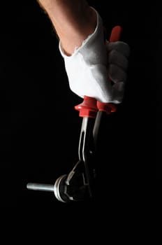 Pliers and a Hand on a Black Background