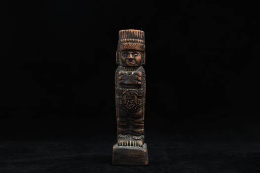 One Ancient Mayan Statue on a Black Background