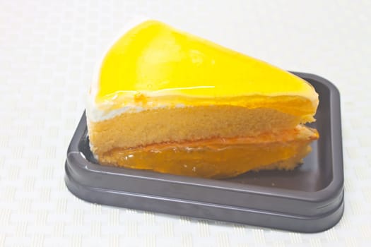 Dessert Orange Cheesecake in plate on background