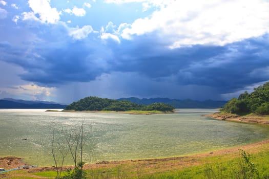 dark storm clouds before rain at over lake