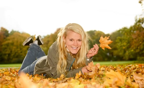 young woman with autumn leaf