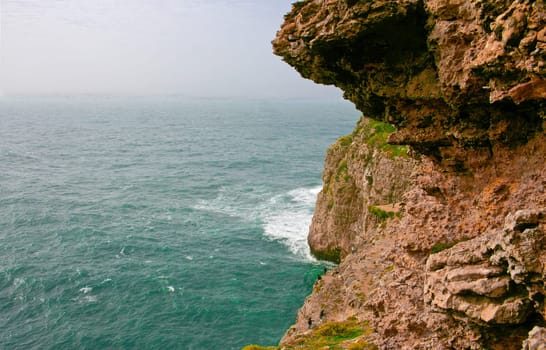Severe dramatic seascape with fishermen in Cape Saint Vicent cliffs, Portugal