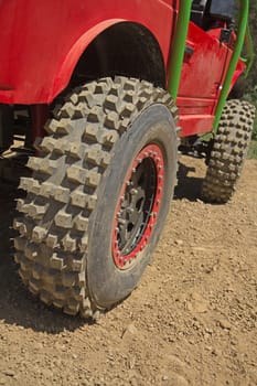 Closeup view of tires on the offroad car.  All potential trademarks are removed.
